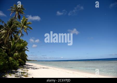 Tropischer Sandstrand mit Kokospalmen und klarem blauen Wasser in Guam, Mikronesien Stockfoto