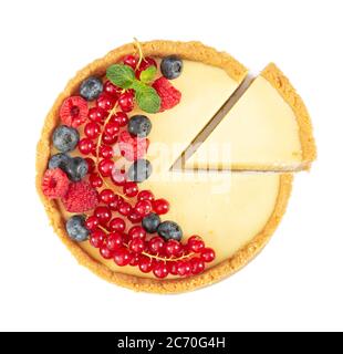 Käsekuchen mit frischen roten Johannisbeeren, Heidelbeeren, Himbeeren und Minzblättern isoliert auf weißem Hintergrund. Draufsicht Stockfoto