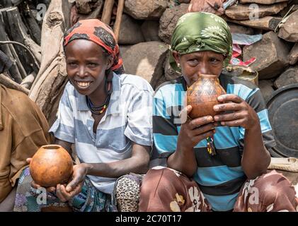 Omo, Äthiopien - September 2017: Unbekannte äthiopische Frauen plaudern und trinken in ihrem Dorf. Stockfoto