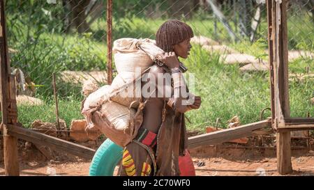 Omo Valley, Äthiopien - September 2017: Unbekannte Frau aus dem Stamm Hamar, die Waren im Omo Valley in Äthiopien transportiert Stockfoto