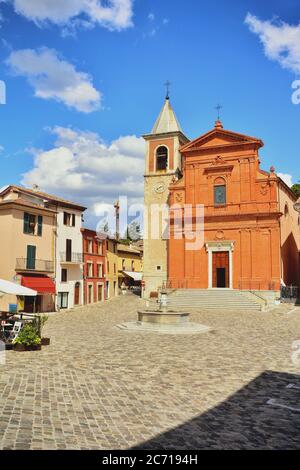 Pennabilli, Rimini, Emilia-Romagna. Der Hauptplatz des Dorfes Pennabilli, im Hinterland von Rimini und die Kathedrale mit ihrer roten Ziegelfassade. Stockfoto