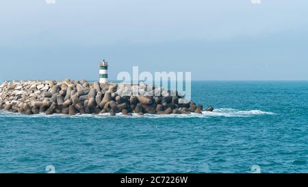 Nazare, Portugal, April 2018: Der grüne Leuchtturm von Porto de Abrigo von Nazare in Zentralportugal Stockfoto