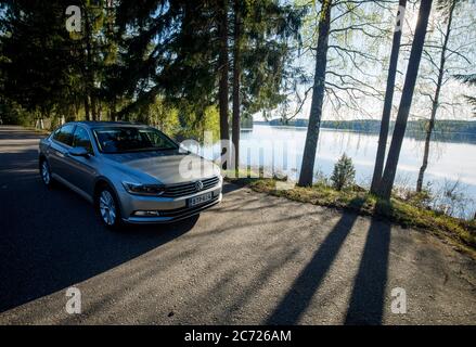 Volkswagen Passat 1.4 tsi Limousine 2015 Modell geparkt am Straßenrand Lay-by an einem See im Sommer , Finnland Stockfoto