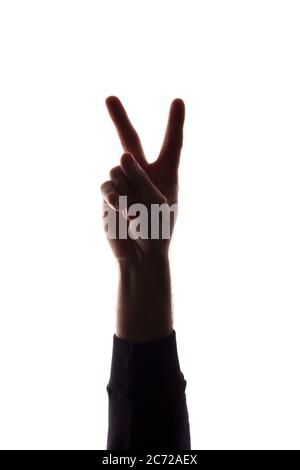 Die Hand eines jungen Mannes mit den Fingern auseinander, Zahl die beiden - Silhouette, Konzept Abstraktion Stockfoto