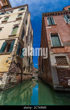 Schmaler Kanal zwischen alten Backsteinhäusern in Venedig, Italien Stockfoto