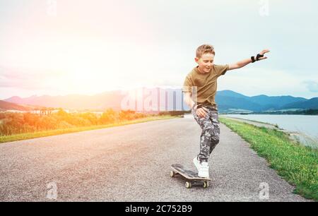 Junge lernen, auf Skateboard zu skaten Stockfoto