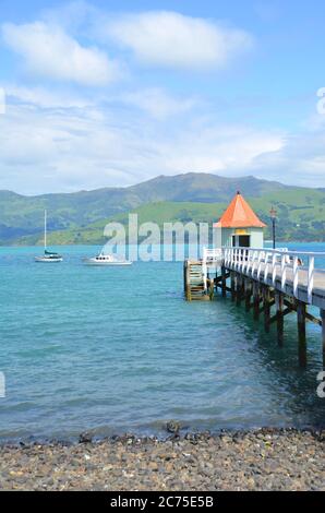 Akaroa, die französischste Stadt Neuseelands, wird Sie mit seinen historischen Gebäuden, dem herrlichen Hafen und der Leidenschaft für gutes Essen begeistern. Stockfoto