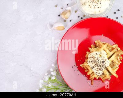 Zucchini Waffeln auf einem roten Teller mit Sauce und Gewürzen. Draufsicht. Essen gesunde Ernährung Konzept. Stockfoto