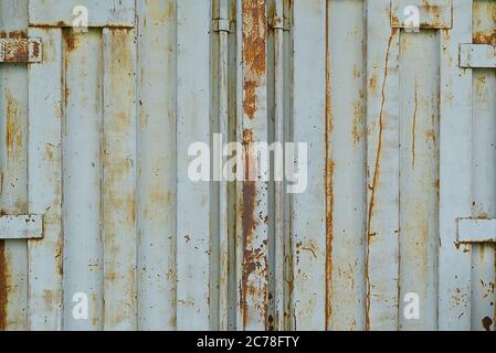 Tür eines stahlgrauen alten rostigen Seefrachtcontainers, Textur, Hintergrund. Stockfoto