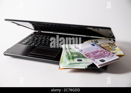 Bamberg, Deutschland 13. Juli 2020: Symbolbilder - 2020 mehrere Tausend Euro in bar mit den Werten von 500 Euro, 200 Euro, 100 Euro und 50 Euro sind auf einem Laptop Internetkriminalität, Cyberkriminalität, weltweit im Einsatz Stockfoto