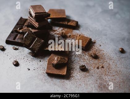 Schokolade Stücke und Chips Foto mit Kopierraum gebrochen dunkel und Milch Schokolade und Kaffeebohnen auf hellem Hintergrund Stockfoto