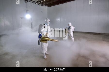 Peking, China. Juli 2020. Mitarbeiter desinfizieren das Kühllager für Fleisch bei der Beijing Ershang Meat Food Group Co., Ltd. In Peking, Hauptstadt von China, 14. Juli 2020. Beijing Ershang Meat Food Group Co., Ltd. Ist eines der größten Unternehmen, das Fleisch für den Pekinger Markt liefert. Während der COVID-19 Pandemie hat das Unternehmen strenge COVID-19-Präventions- und Kontrollmaßnahmen entlang der gesamten Lieferkette ergriffen, um die Sicherheit von Fleischprodukten und den regelmäßigen Betrieb seiner Verarbeitungsfabriken zu gewährleisten, um der Marktnachfrage gerecht zu werden. Quelle: Li Xin/Xinhua/Alamy Live News Stockfoto