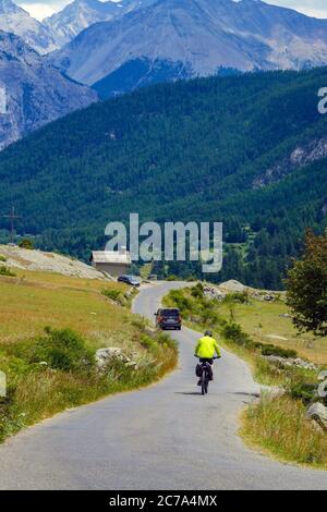 Radfahrer, Auto und Kapelle, die Vallee de Claree, in der Nähe von Briancon, Französisch Alpen, Frankreich im Sommer Stockfoto