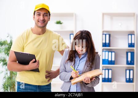 Junge Kurier Lieferung Paket an das Büro Stockfoto
