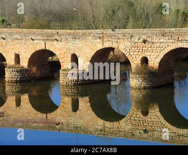 Merida, Badajoz, Extremadura, Spanien. Die römische Brücke, die auf dem Guadiana Fluss reflektiert. UNESCO-Weltkulturerbe. Stockfoto