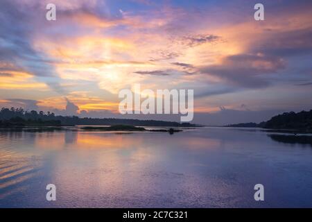 Sonnenuntergang Blick auf den Victoria Nil Fluss, mit Bäumen wachsen und die Reflexionen auf dem Wasser, Jinja, Uganda, Afrika Stockfoto