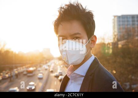 Draußen trägt eine Maske des jungen Mannes Stockfoto