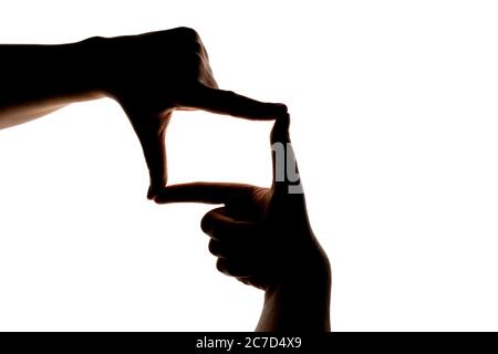 Silhouette der Hand zeigt Foto Frame Geste isoliert auf weißem Hintergrund. Leer oder Modell für Design. Stockfoto