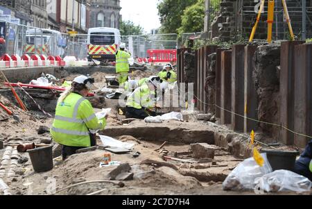 Archäologen von den Straßenbahnen nach Newhaven Projekt Ausgraben von menschlichen Überresten, die bis zu 1300 zurückreichen könnte, aus den Gräbern der South Leith Pfarrkirche, deren mittelalterlicher Friedhof erstreckt sich unter der Straßenoberfläche der Constitution Street, Leith. Stockfoto