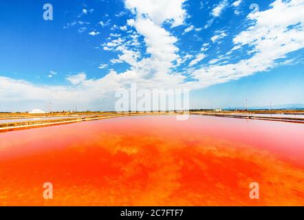 Lago di Sale rosso con riflesso cielo nuvoloso, presso le saline Conti Vecchi, uno spettacolo della natura Stockfoto