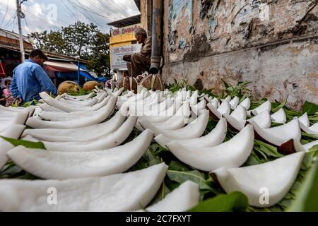 Kokosscheiben auf einer Straßenplattform in der heiligen Stadt Rishikesh am Ufer des Flusses Ganges in Nordindien angeordnet Stockfoto