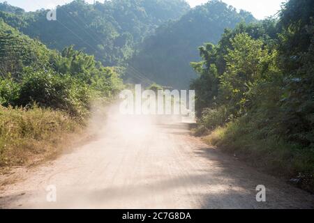 Eine Staubstraße im Dorf Huay Xai in Lao am Mekong-Fluss aus der Sicht im Nordwesten Laos in Lao. Lao, Huay Xay, November 2019 Stockfoto