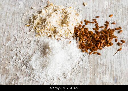 Kokosnuss, Semmelbrösel und Leinsamen auf dem weißen Holzhintergrund Stockfoto