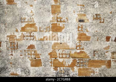 Alte Ziegel mit Zementflecken, Detail der Verlassenheit und Ruine auf der Fassade Stockfoto