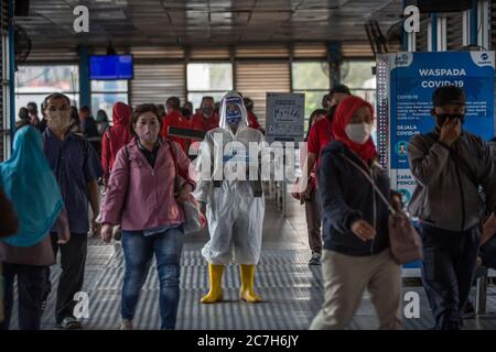 Jakarta, Jakarta, Indonesien. Juli 2020. Ein Mitarbeiter, der Schutzkleidung trägt, hält am 17. Juli 2020 an der Harmoni Central Busway Station in Jakarta, Indonesien, ein Transparent mit Informationen über das Virus und die Infizierten. Nach Angaben des Gesundheitsministeriums stiegen die COVID-19-Fälle in Indonesien innerhalb eines Tages um 1,462 auf 83,130, wobei die Zahl der Todesopfer um 84 auf 3,957 ansteigt. In den letzten 24 Stunden verzeichneten neun Provinzen eine hohe Zahl von Fällen. Quelle: Ariadi Hikmal/ZUMA Wire/Alamy Live News Stockfoto