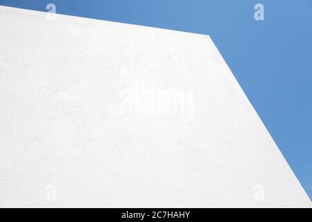 Strukturiert Weißer Betonhintergrund auf blauem Himmel Hintergrund. Wand weiß lackiert. Modell Stockfoto