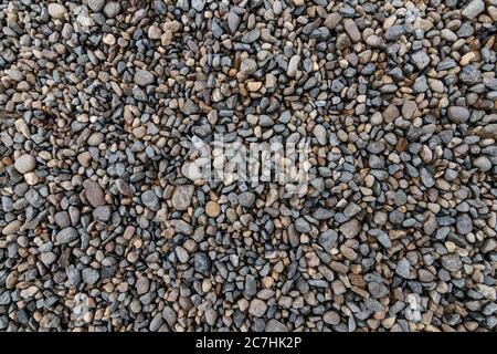 Draufsicht auf die Kieselsteine Stein auf dem Boden. Schöne kleine Stein auf dem Strand Hintergrundstruktur. Stockfoto