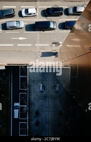 Vertikale Aufnahme von Autos auf der Autobahn in der Nähe eines hohen Gebäudes in Lille, Frankreich Stockfoto