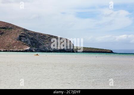 Ein Mann, der mit seinem Kajak auf einer Sandbank in Balandra Beach, BCS Mexiko, gestrandet ist. Stockfoto