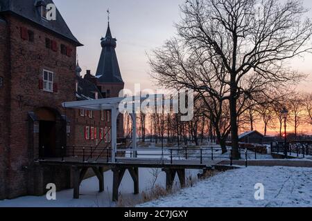 Faszinierender Sonnenaufgang über dem historischen Schloss Doorwerth im Winter Niederlande Stockfoto