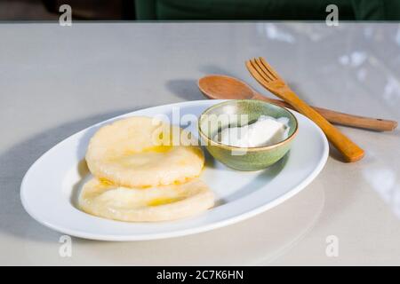 Käseknödel auf dem weißen Teller, in grüner Schüssel aufgesüßen. Traditionelle georgische Küche. Käse Khin. Stockfoto