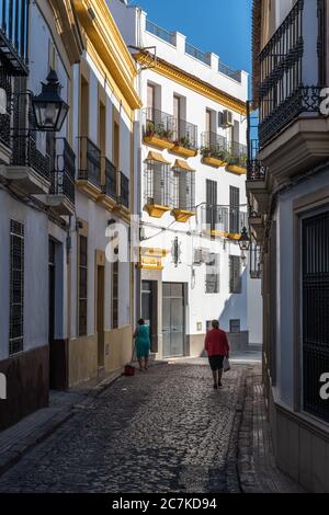 Ein weiß getünschter Apartmentblock in Cordobas enger Calle Juan Rufo, der von der starken Morgensonne beleuchtet wird Stockfoto