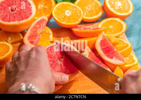 Frisch geschnittene Grapefruit und Orangenscheiben mit blauem Holzhintergrund. Stockfoto