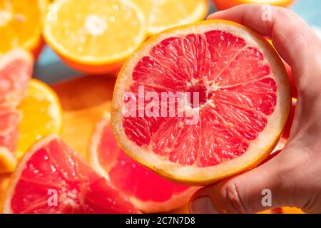 Frisch geschnittene Grapefruit und Orangenscheiben mit blauem Holzhintergrund. Stockfoto