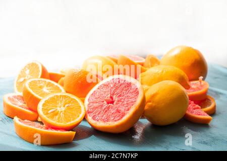 Frisch geschnittene Grapefruit und Orangenscheiben mit blauem Holzhintergrund. Stockfoto