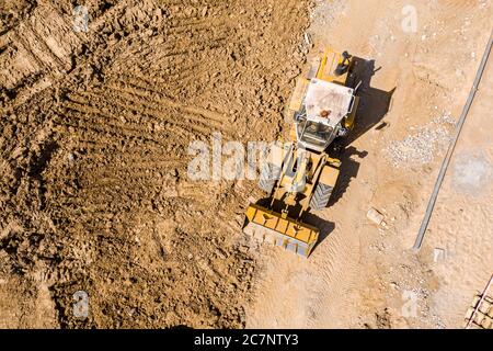 Luftaufnahme von oben auf der Baustelle der gelben Radlader. Schwere Industriemaschinen Konzept Stockfoto