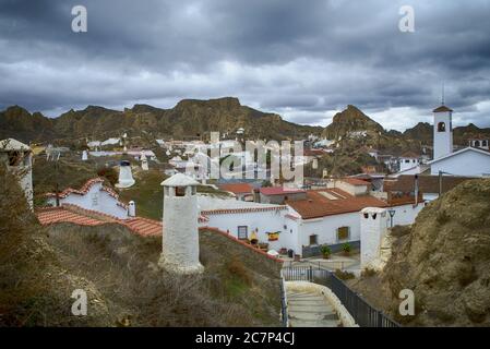 Schöne Aussicht auf weiße Häuser mit Ziegeldächern in Guadix, Spanien an einem bewölkten Tag Stockfoto