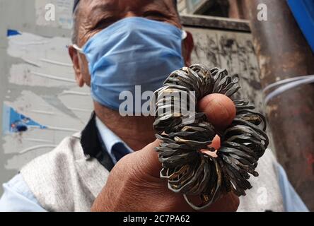 Kathmandu, Nepal. Juli 2020. Ein Ladenbesitzer zeigt Kunden am 19. Juli 2020 auf dem Ghantakarna-Festival in Kathmandu, der Hauptstadt Nepals, eine Reihe von Ringen. Die Newar-Gemeinde des Kathmandu-Tals beobachtet Ghantakarna, ein Fest, um böse Geister zu vertreiben und Glück zu bringen. Menschen tragen Metallringe, um sich vor allen Übel und bösen Geistern zu schützen. Kredit: Sunil Sharma/ZUMA Wire/Alamy Live Nachrichten Stockfoto