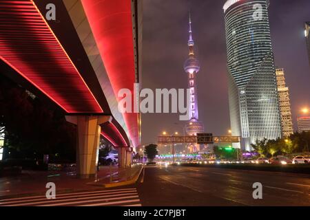 Nachtszene des modernen Shanghai Pudong. Highway unter leuchtender roter Überführung. Berühmte Oriental Pearl TV Tower und Gebäude Stockfoto