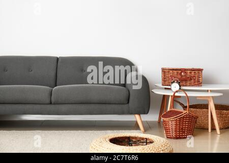 Sofa, Tisch und Korbkörbe im Zimmer Stockfoto