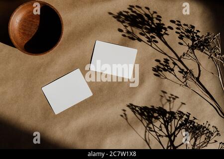Draufsicht auf leere Papierkarten auf Kraftpapier. Modell für Geschäftsvorlage. Stockfoto
