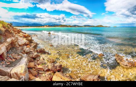 Die Bucht von Nora und der Strand, die mittelalterliche Kirche Sant'Efisio in der Nähe des Ufers und die Berge im Hintergrund. Ort: Nora, Pula, Sardinien, Italien Europa Stockfoto