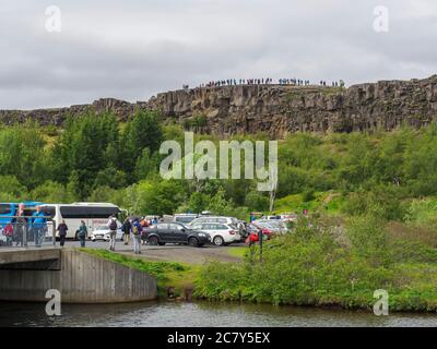 Island, Thingvellir, 1. Juli 2018 Blick auf Auto und Busse Parkplatz im Thingvellir Nationalpark und Touristen auf Aussichtsplattform auf Thingvellir ist Stockfoto