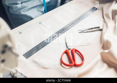 Stillleben Foto einer Mustervorlage mit Maßband, Kreide und Schere. Nähwerkzeuge und Zubehör. Stockfoto