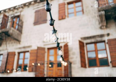 Girlande von Glühlampen vor dem Hintergrund der alten Villa. Stockfoto