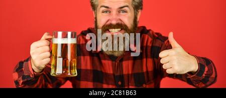 Toasting und jubelnden Aperitif. Freizeit und Feier. Mann trinkt Bier in der Bar. Bier mit Schaum. Brutal Hipster trinken Bier. Reife bärtige Barkeeper halten Bierglas. Zuversichtlich Barkeeper Anheben Toast. Stockfoto